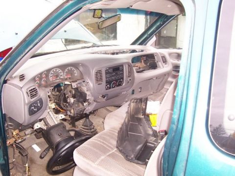 2007 Ford Mustang - The interior of a truck is shown with the dashboard disassembled, revealing the steering column and exposed wiring.