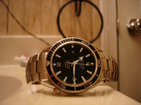 1994 Ford Bronco - Close-up of an Omega Seamaster watch with a black dial and metal bracelet.