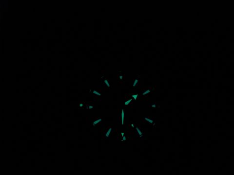 1994 Ford Bronco - A close-up view of a watch face with glowing markers and hands in the dark.
