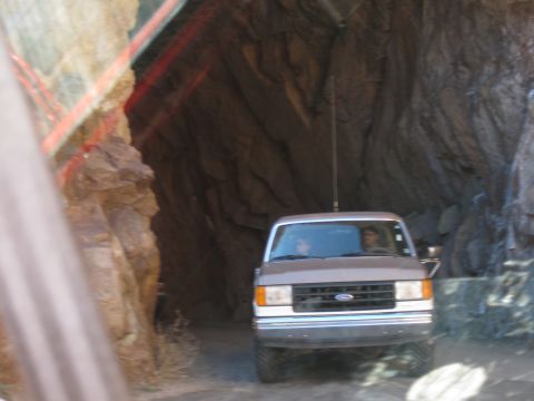 1993 Ford Bronco - A 1992 Ford Bronco is seen from the front as it drives through a narrow, rocky tunnel.