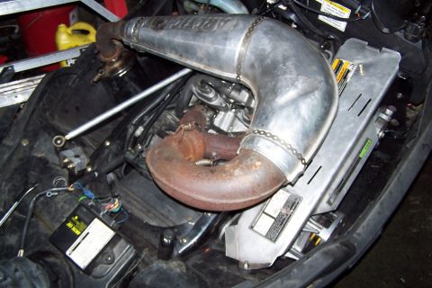 2004 Arctic Cat F-7 Firecat - Engine compartment of a 2004 Arctic Cat F-7 Firecat snowmobile, showing the exhaust pipe and electrical components.