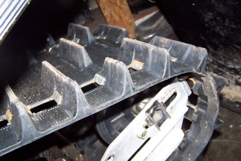 2004 Arctic Cat F-7 Firecat - Close-up of a snowmobile track, showing its tread pattern and construction details.