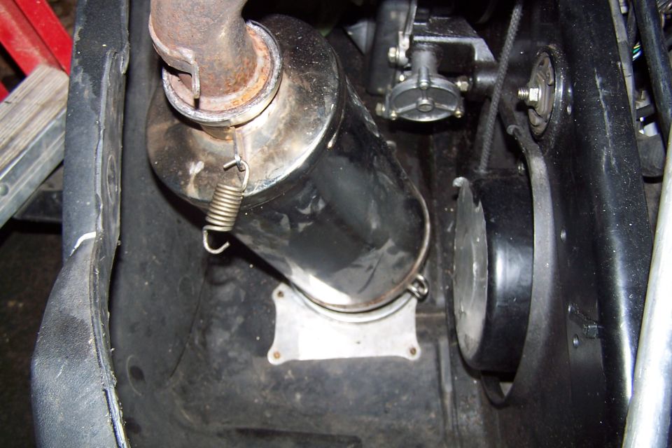 Close-up of snowmobile exhaust pipe and drive belt cover