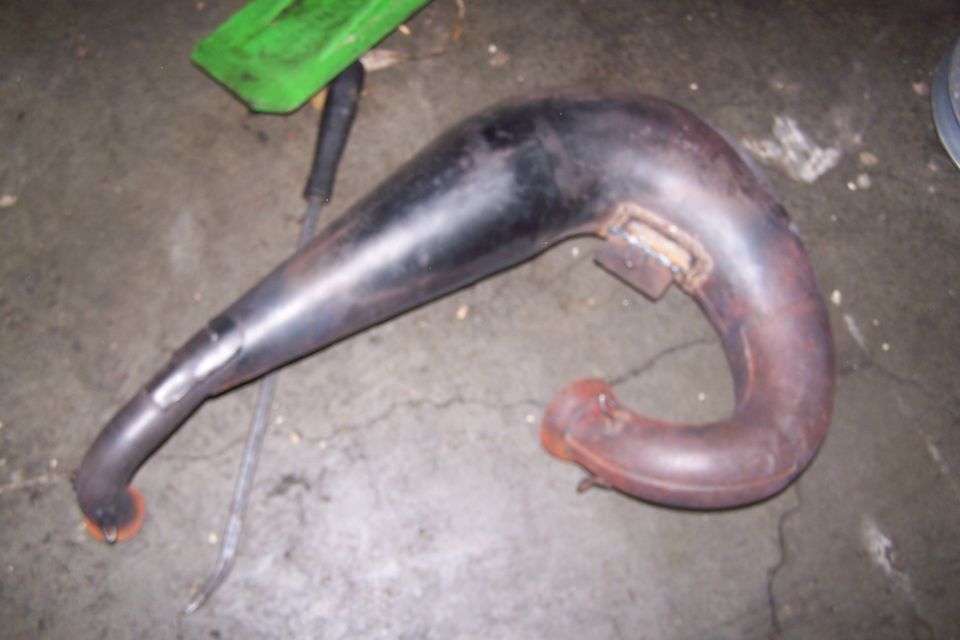 Exhaust pipe with a green plastic piece in the background