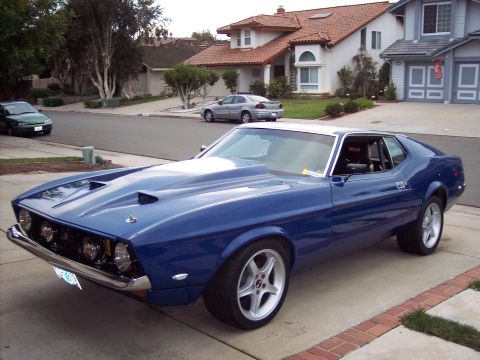 1971 Ford Mustang - This blue 1971 Ford Mustang features a large hood scoop and custom wheels.