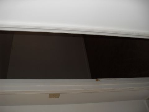 1988 Ford Bronco - The photo shows the interior of a doorway leading into a dark space, with a light switch on the frame.