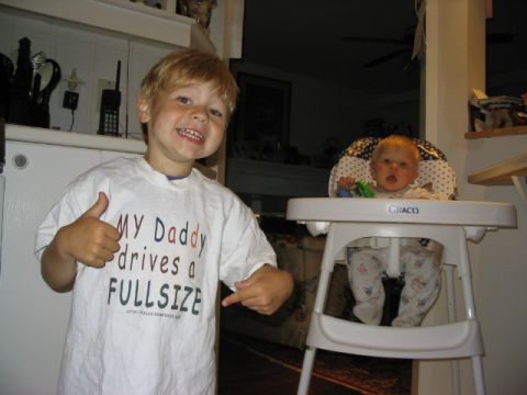 1986 Ford Bronco - A young boy proudly displays his t-shirt indicating his father drives a full-size vehicle.
