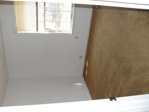 1988 Ford Bronco - Interior of a room carpeted flooring and a window with blinds.