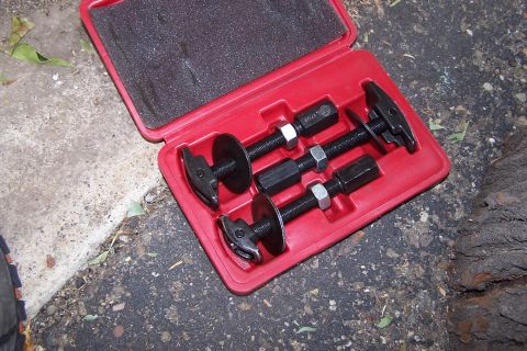 1990 Ford Bronco - A red case holds a ball joint press tool kit with multiple components for automotive repair.
