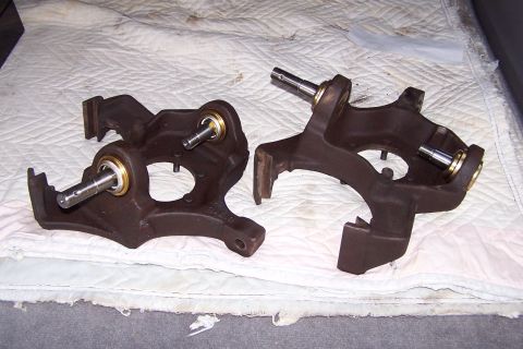 1990 Ford Bronco - Two ball joint assemblies, likely for a truck or SUV, are laid out on a white quilted surface.