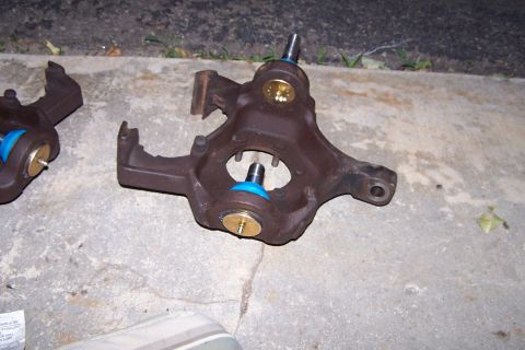 1990 Ford Bronco - Ball joint assemblies, likely for a truck or SUV, are shown resting on concrete.
