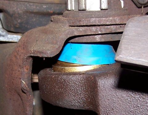 1990 Ford Bronco - Close-up view of a ball joint a blue polyurethane bushing and a brass washer, likely a suspension component.