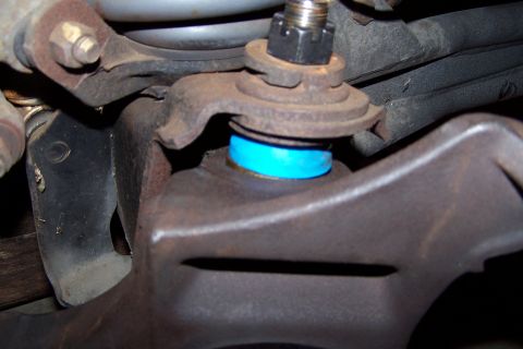 1990 Ford Bronco - Ball joint assembly with a blue boot and castle nut visible.