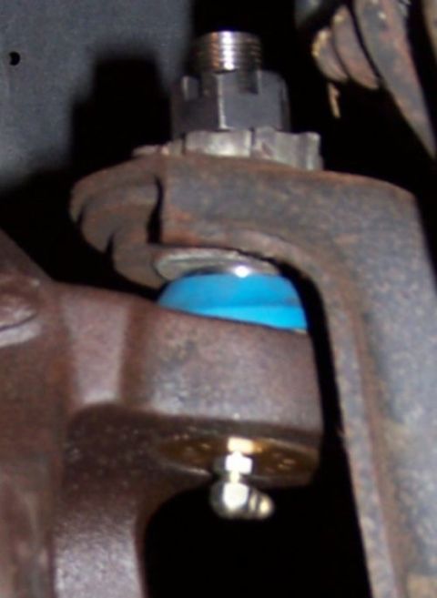1990 Ford Bronco - Close-up view of a vehicle's ball joint assembly.