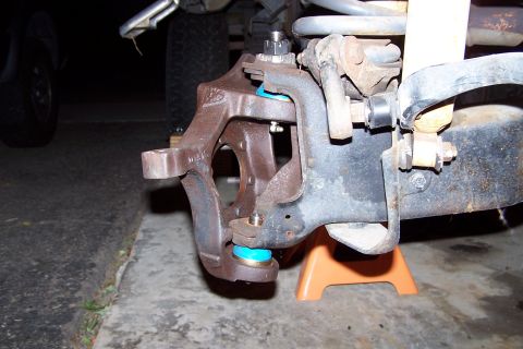 1990 Ford Bronco - Close-up view of a vehicle's ball joint assembly, a bright blue polyurethane boot.