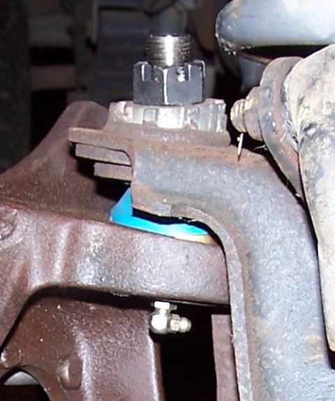 1990 Ford Bronco - Close-up of a vehicle's ball joint assembly, showing mechanical components.