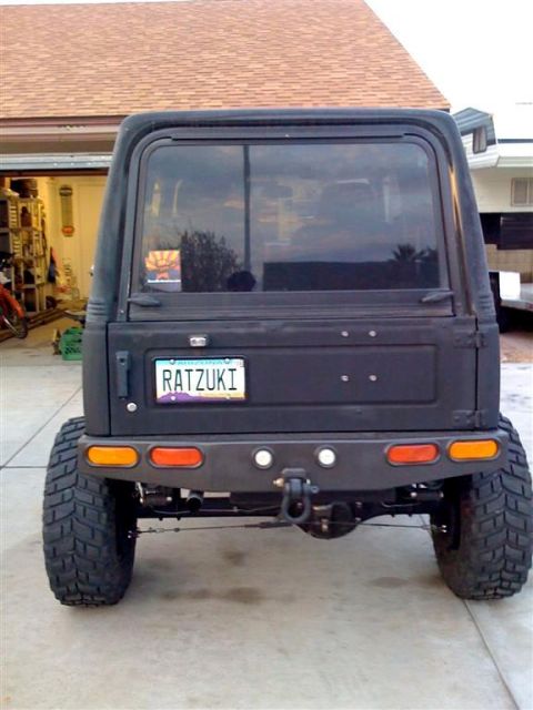 1987 Suzuki Samurai - Rear view of a modified 1987 Suzuki Samurai showing its custom bumper and off-road tires.