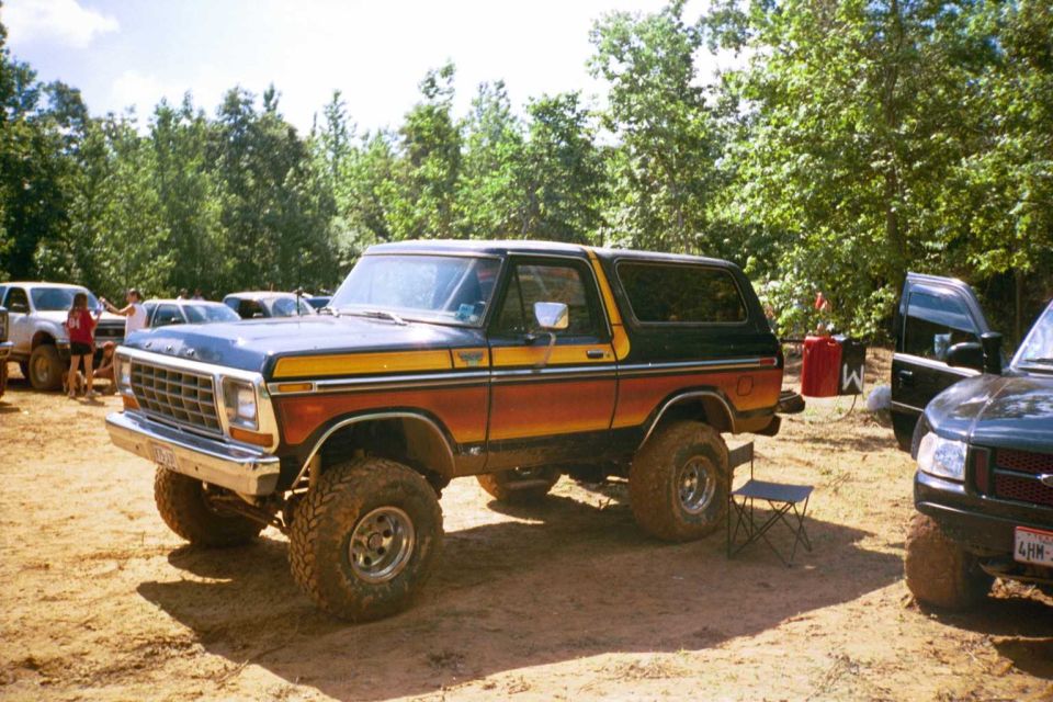 1979 Ford Bronco, side view, two-tone orange and blue with yellow stripe