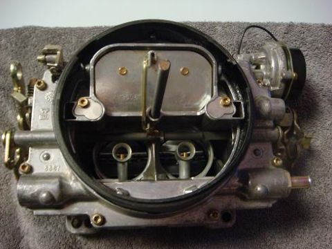 1975 Chevrolet Corvette - Close-up view of a carburetor, showing internal components and external linkages.