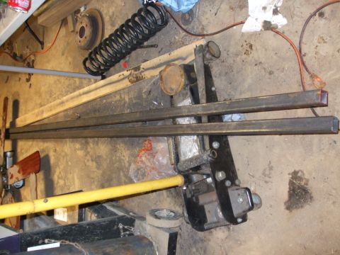 1996 Jeep Grand Cherokee - A collection of automotive parts and tools are scattered across a garage floor.