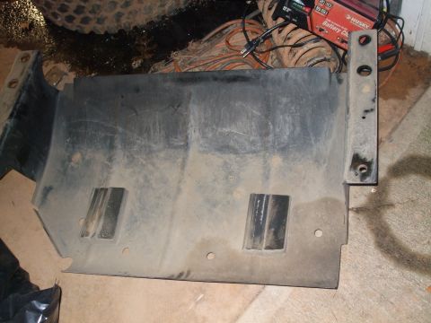1996 Jeep Grand Cherokee - A black skid plate with a metal bracket is shown, likely a vehicle part.
