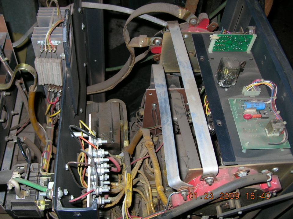 Welding machine interior with exposed wires, circuit boards, and metal components. Date stamp reads 01.23.2009
