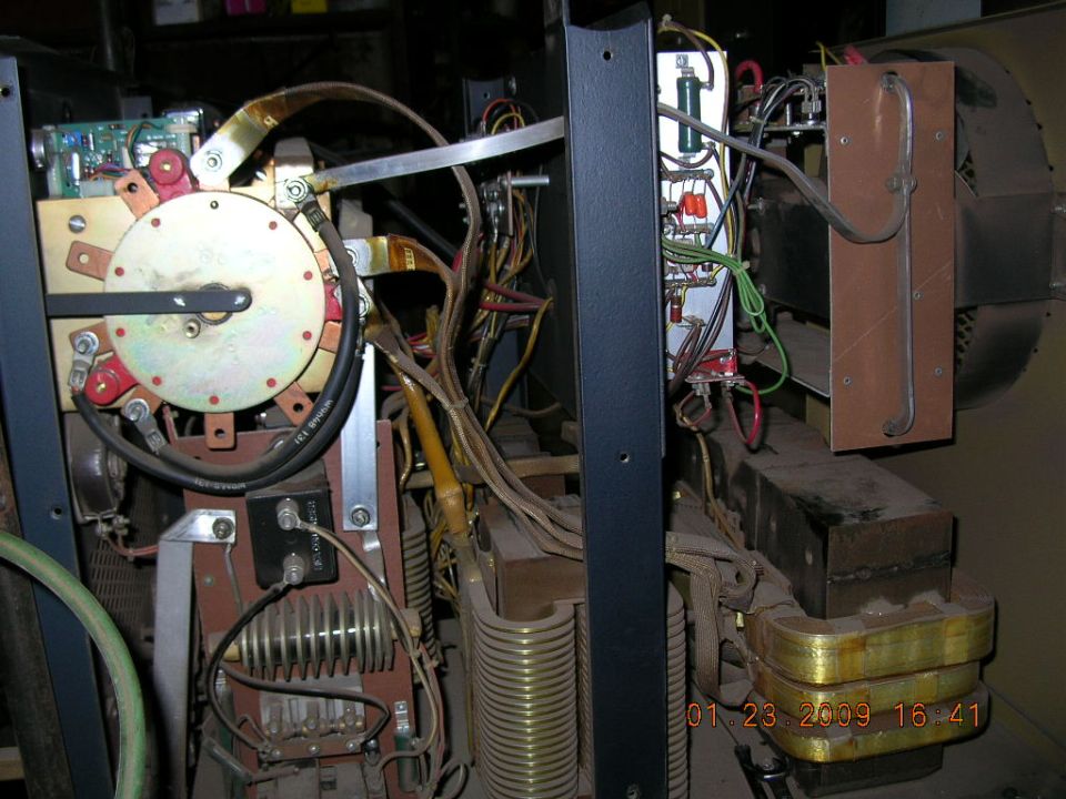 Welding machine interior with transformer, fan, and wiring