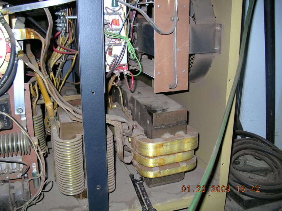 Inside of a welding machine with transformers, wires, and a fan visible. Date stamp reads 01.23.2009