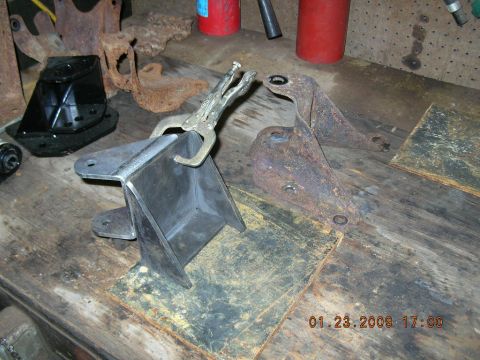 1997 Ford F-250 - Metal brackets are being worked on with vise grips on a workbench. The date 01.23.2009 is visible.