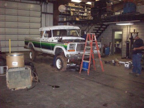 1978 Ford Bronco - 1978 Ford F-Series truck in garage, undergoing repairs. Hood is open, and a radiator is on the floor.