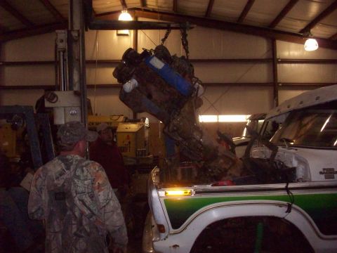 1978 Ford Bronco - Engine removal in progress for a white and green Ford truck, identified as a 1977 model by its badge.