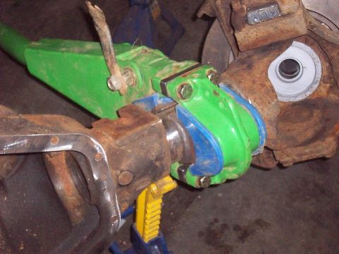 1978 Ford Bronco - This image shows a close-up view of a vehicle's axle and suspension components, with some parts painted green and blue.