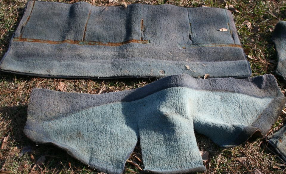 Worn blue carpet pieces on the ground