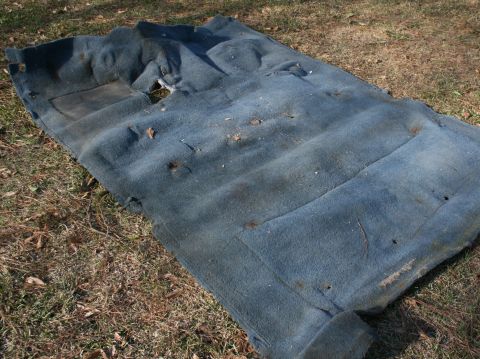 1991 Ford C-350 (Centurion Conversions) - This is a blue automotive carpet, likely removed from a vehicle, showing signs of wear and tear.