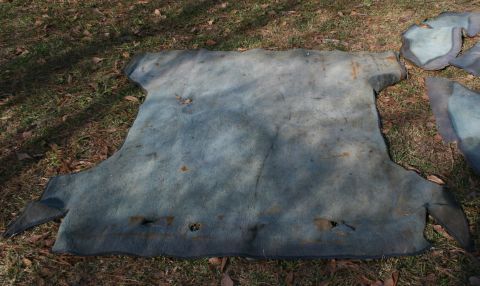 1991 Ford C-350 (Centurion Conversions) - Blue carpet pieces are shown on the ground, possibly from a vehicle interior.