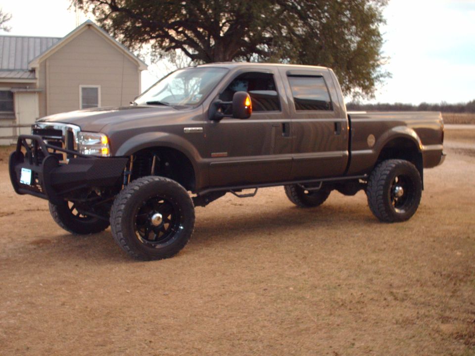 Lifted dark brown Ford F-250 Super Duty pickup truck with custom bumper