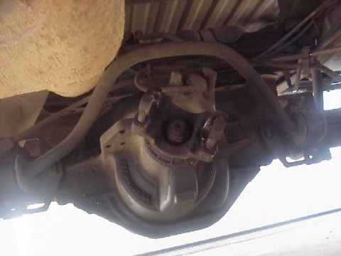 1989 Ford Bronco - Underside view of a vehicle's rear differential and driveshaft connection.