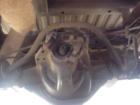 1989 Ford Bronco - Underside view of a vehicle's rear differential and suspension system, showing mechanical parts.