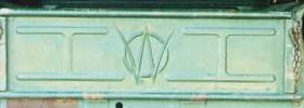 1991 Ford Bronco - The rear tailgate of a light green vehicle features a raised emblem with two rectangular panels on either side of a central circular design…
