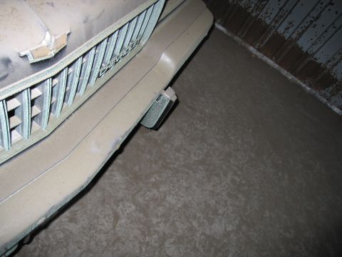 1991 Ford LTD Crown Victoria - Photograph of the dust-covered front grille and bumper of a stored Chevrolet, not a technical document.