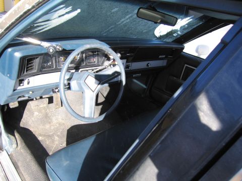1991 Ford LTD Crown Victoria - Photo of the blue dashboard and steering wheel interior of an older Chevrolet sedan.