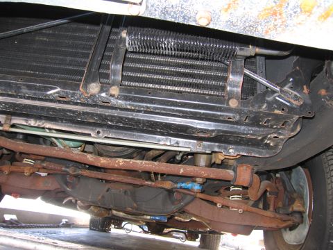1991 Ford LTD Crown Victoria - Photograph of the front undercarriage of a vehicle showing the radiator, frame and corroded suspension parts.