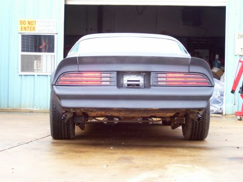 1978 Pontiac Trans Am - Rear view of a 1978 Pontiac Trans Am in primer, parked in a garage.