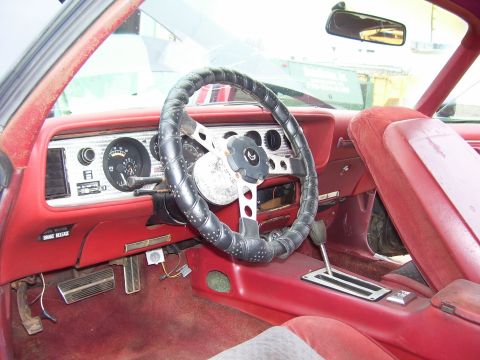 1978 Pontiac Trans Am - Interior view of a 1978 Pontiac Trans Am, its red dashboard and seats.