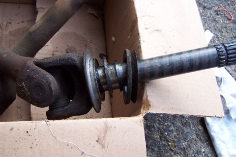 1990 Ford Bronco - A close-up view of a driveshaft component, showing a Spicer U-joint and a splined shaft end.