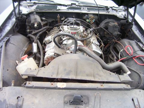 1978 Pontiac Trans Am - The engine bay of a car, a V8 engine with a carburetor and various hoses. The SuperMotors.net logo is visible at the bottom right.