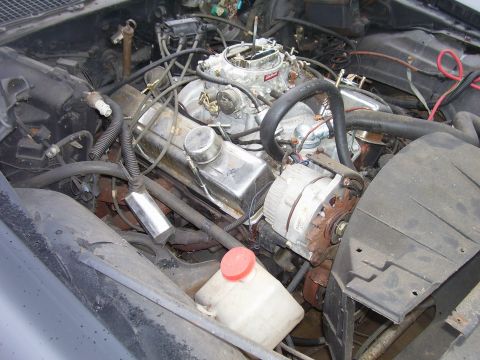 1978 Pontiac Trans Am - Close-up of a V8 engine bay, the carburetor and alternator.