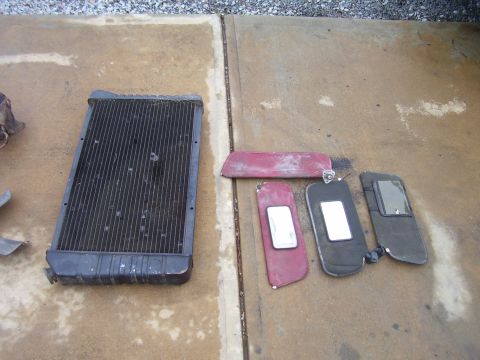 1978 Pontiac Trans Am - A radiator and several sun visors are laid out on a concrete surface.