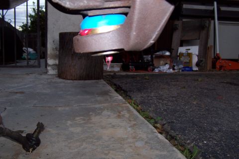 1990 Ford Bronco - Ball joint assembly, likely from a vehicle's suspension, with fresh grease applied.