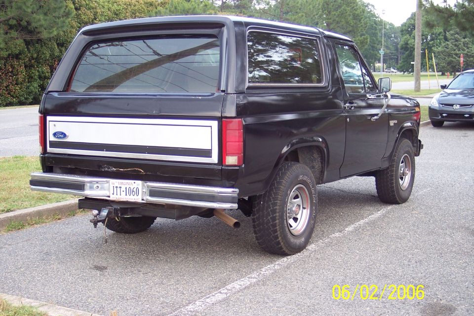 Black Ford Bronco SUV, rear three-quarter view, white tailgate panel, Virginia plate JTT-1060, parked in a lot